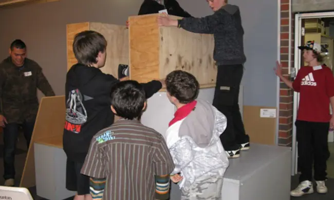 Boys Building With Large Wooden Boxes